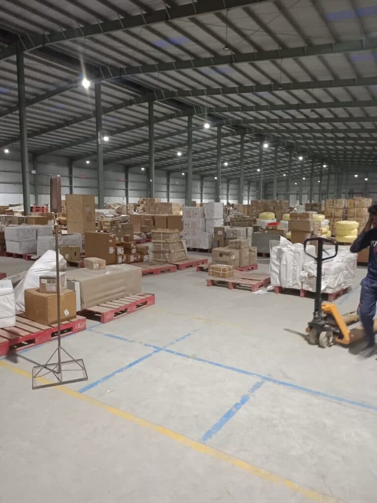 Staff moving boxes into a storage unit